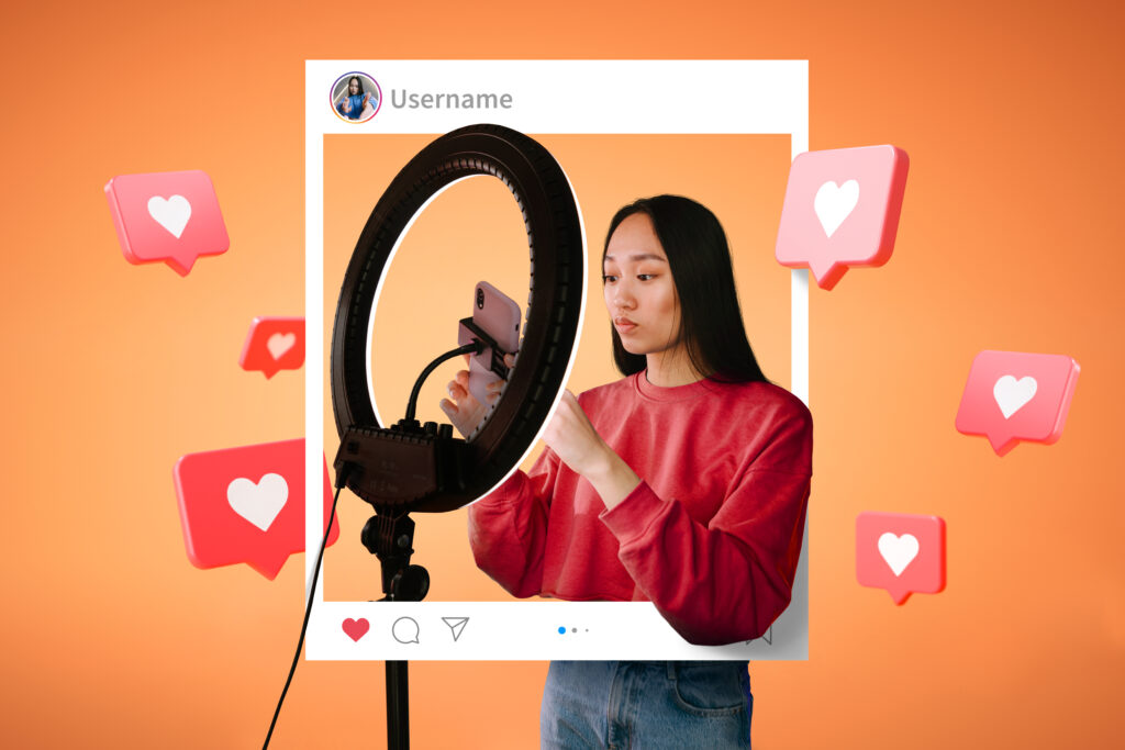 Young woman using a smartphone and ring light, framed inside a social media post layout with floating heart icons, representing an influencer or content creator generating user engagement online.